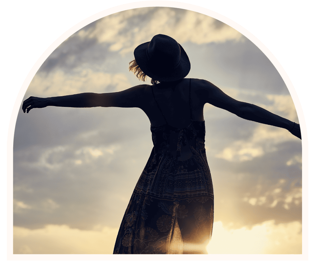 Silhouette of a woman dancing in the sunset, surrendering to the divine guidance of her creator.